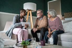 A man and two women sitting on a couch talking to a doctor about sexually transmitted infections.