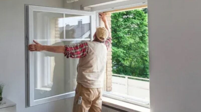 A man carefully installs a window in a room, ensuring a precise fit and proper alignment for optimal functionality.